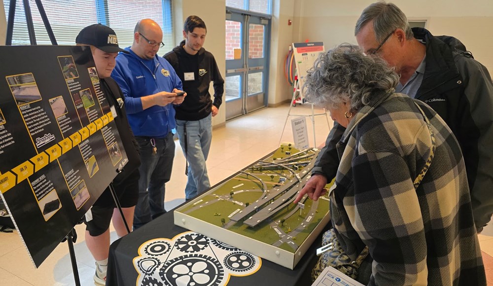 attendees looking at a model at the event