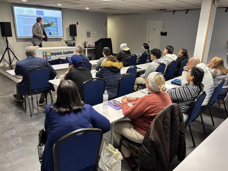 event attendees watching listening to the presentation
