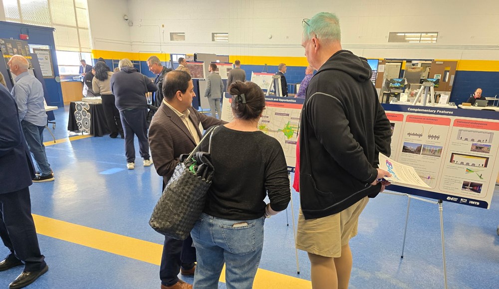 attendees looking at presentation boards at the event