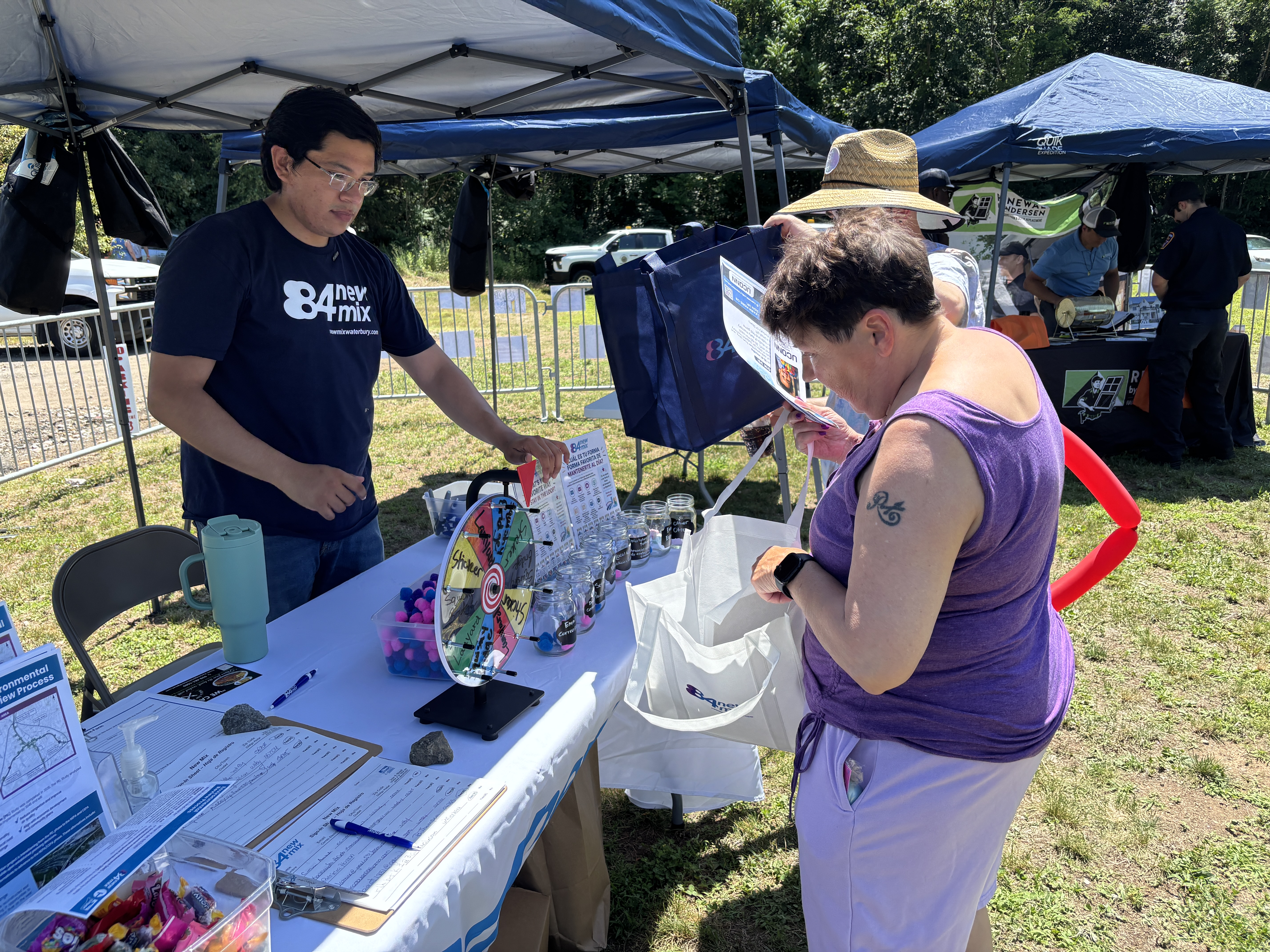 New Mix staff talking to an attendee at the event